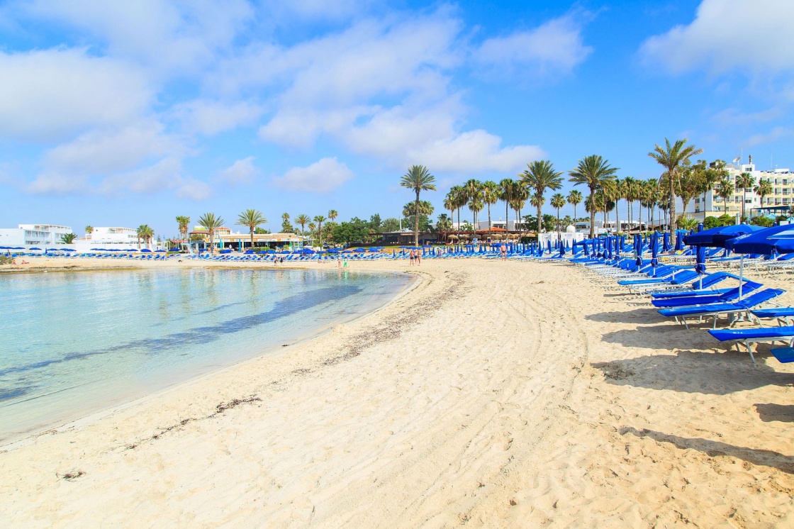 'Blue beach umbrellas and sunbeds on Sandy Beach in Ayia Napa, Cyprus' - Cyprus