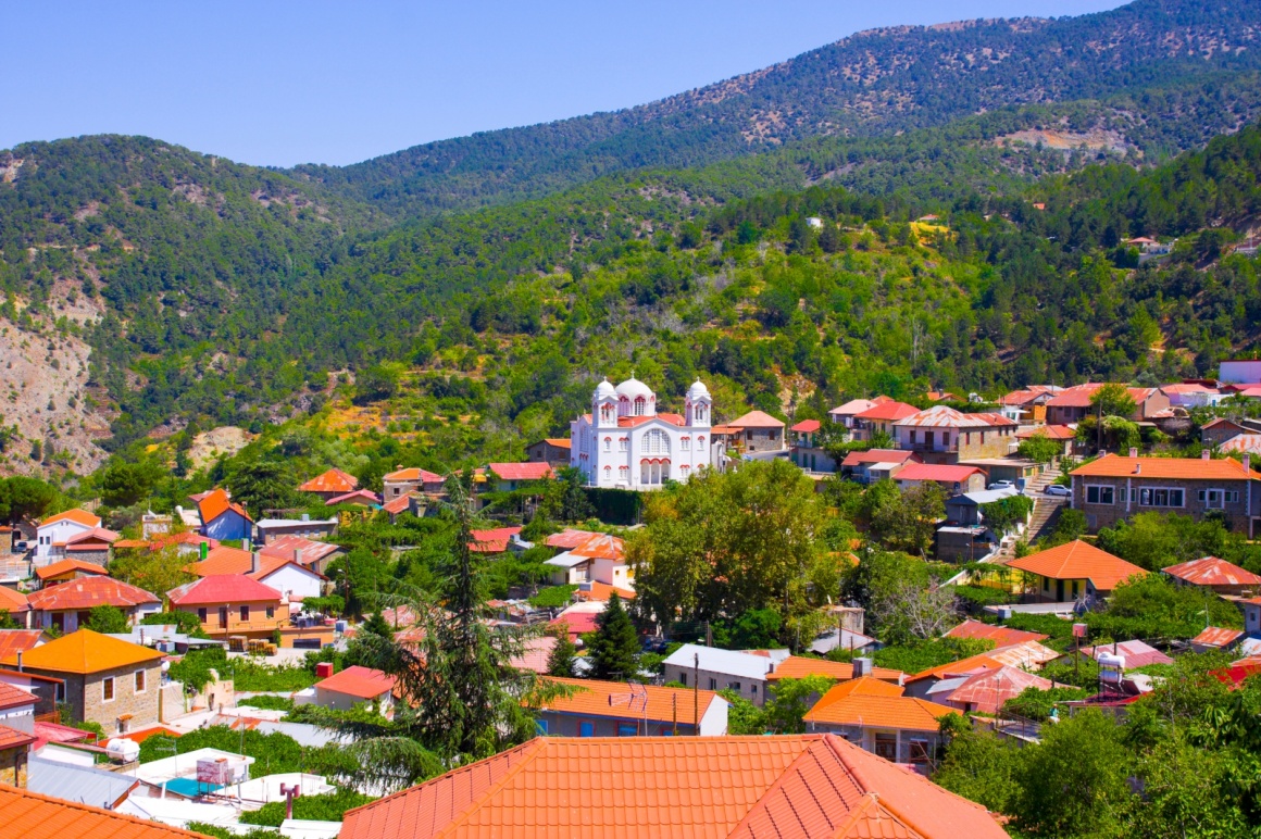 'Mountain Village Pedoulas, Cyprus. View over roofs of houses, mountains and Big church of Holy Cross. Village is one of most picturesque villages of Troodos mountain range ' - Cyprus